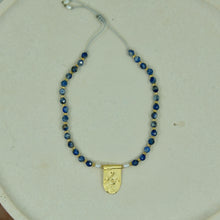 Load image into Gallery viewer, lapis bracelet with silver and gold-plated pendant, and blue lapis beads strung on an adjustable thread