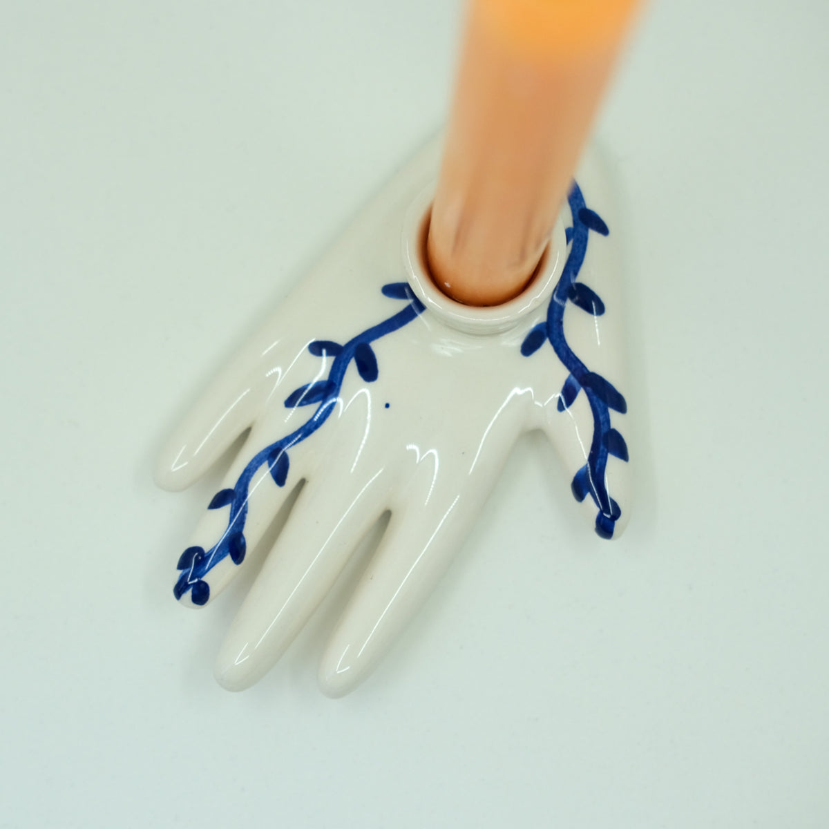ceramic candle holder with blue hand-painted designs leaves vines